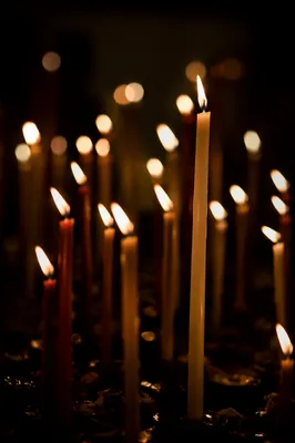 Burning Candles in Dark Faithful Stillness