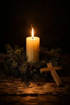 Burning Candle with Evergreen Wreath and Cross