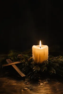 Burning Candle with Evergreen Faith Cross
