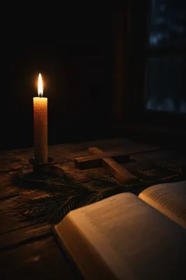 Burning Candle with Cross and Evergreen