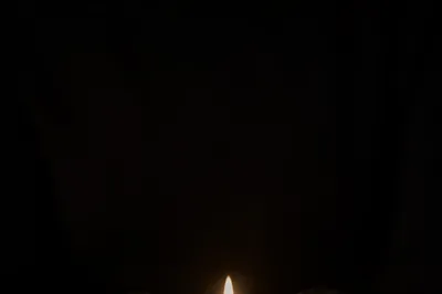 Faith Candle Held in Gentle Hands