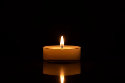 Burning Candle in Quiet Darkness