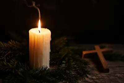 Burning Candle With Evergreen Faith Cross