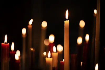 Burning Candles in Dark Faithful Stillness