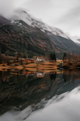 Peaceful Morning Lake Reflection with Mountain Cabins
