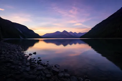 Calm Morning Lake with Evergreen Mountains