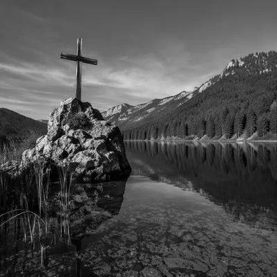 Weathered Cross Reflected in Mountain Lake