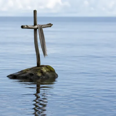 Weathered Cross Reflected in Still Water