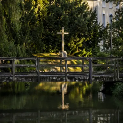 Wooden Cross Reflected in Evergreen River