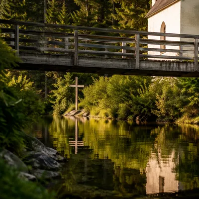 Wooden Cross Reflected in Evergreen Waters
