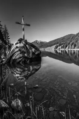 Weathered Cross Reflected in Mountain Lake