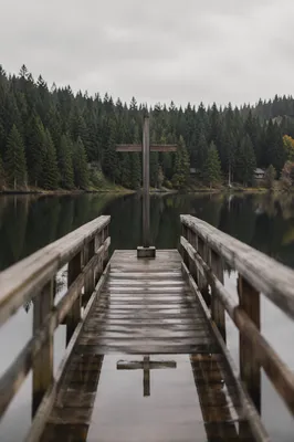 Wooden Cross Reflected on Quiet Evergreen Lake
