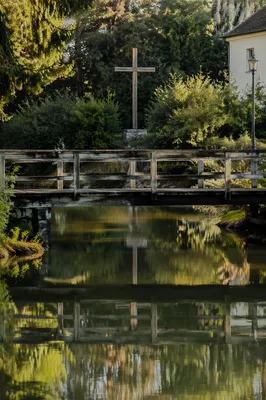 Wooden Cross Reflected in Evergreen River