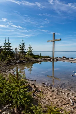 Wooden Cross Reflected in Quiet Lakeshore