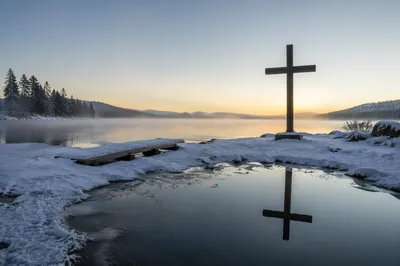 Wooden Cross Reflected on Frozen Lake