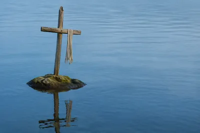 Weathered Cross Reflected in Still Water