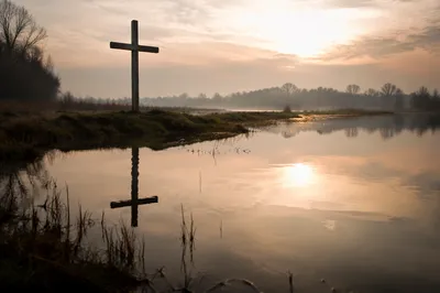 Wooden Cross Reflected in Misty Wetland