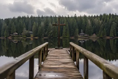 Wooden Cross Reflected on Quiet Evergreen Lake