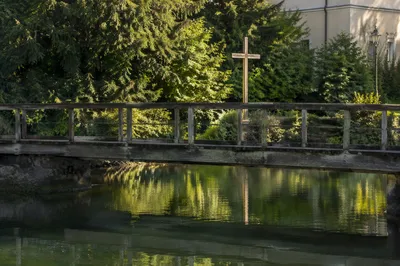 Wooden Cross Reflected in Evergreen River