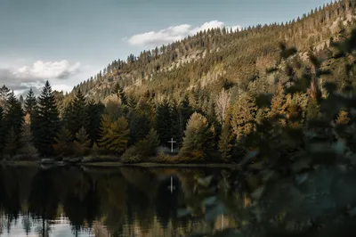 White Cross Reflected in Still Mountain Lake