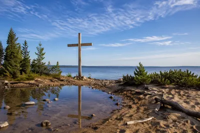 Wooden Cross Reflected in Still Lakeshore Water