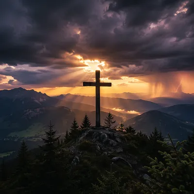 Cross Silhouette Under Stormy Mountain Light Rays