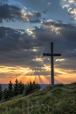 Wooden Cross Beneath Hopeful Sunset Rays