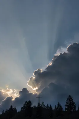 Wooden Cross Beneath Hopeful Storm Light