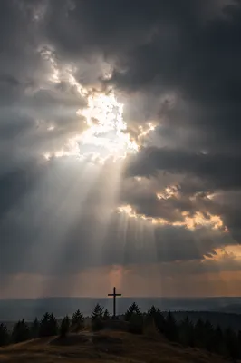 Wooden Cross Beneath Storm Cloud Light Rays