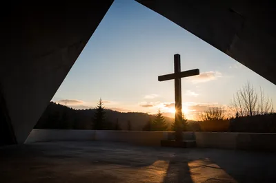 Wooden Cross Illuminated by Golden Light Rays