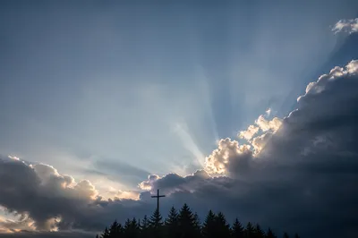 Wooden Cross Beneath Hopeful Storm Light