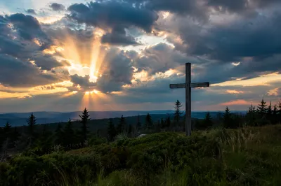 Wooden Cross Under Golden Sunset Rays
