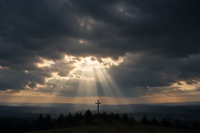 Wooden Cross Beneath Stormy Light Rays