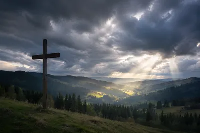 Wooden Cross Beneath Stormy Heavenly Rays