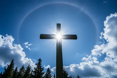 Wooden Cross with Sunburst in Blue Sky