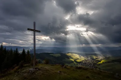 Wooden Cross Beneath Breaking Light Rays