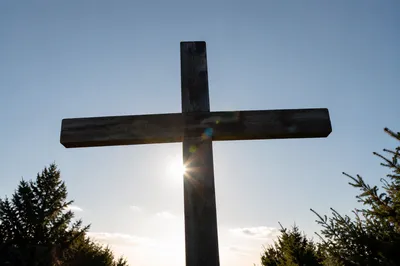 Weathered Cross Beneath Hopeful Light Rays