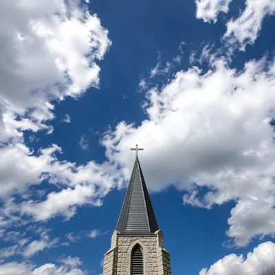 Empty Cross Above Chapel Steeple Sky