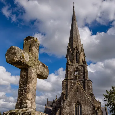Weathered Stone Cross Beneath Blue Sky