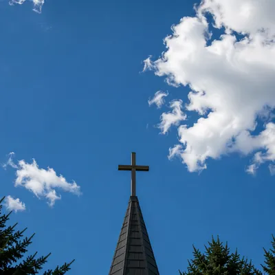 Empty Wooden Cross Under Blue Chapel Sky
