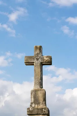 Empty Stone Cross Under Serene Blue Sky