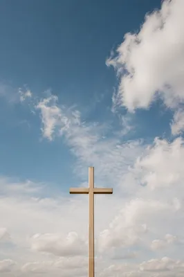 Minimal Wooden Cross Under Blue Sky
