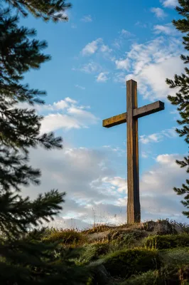 Weathered Wooden Cross Beneath Blue Sky