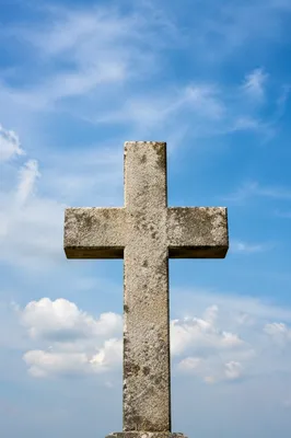 Weathered Stone Cross Beneath Blue Sky