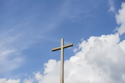 Minimal Wooden Cross Under Blue Sky