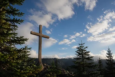Empty Wooden Cross Beneath Blue Clouded Sky