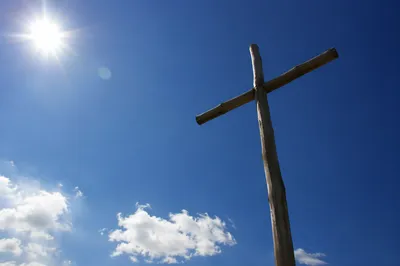 Empty Wooden Cross Beneath Blue Sky