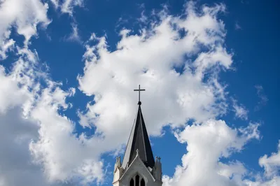 Empty Cross Above Chapel Steeple Sky