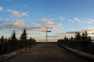 Empty Wooden Cross Under Peaceful Blue Sky