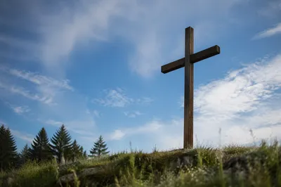 Empty Wooden Cross Beneath Blue Morning Sky